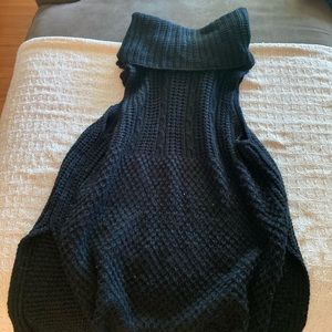 Black turtle neck sweater vest with slit